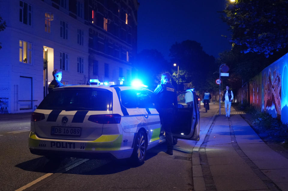 Police work in the Freetown Christiania neighborhood of Copenhagen, Denmark, Saturday, Aug. 26, 2023. Police said two masked gunmen opened fire inside a building in the neighborhood, known for its counterculture vibe and flourishing hashish trade. (Emil Helms/Ritzau Scanpix via AP)