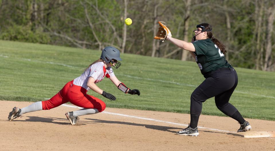 Canton South's Amber Dedmon dives safely back to first base in the third inning during Tuesday's tournament game against Mentor Lake Catholic.