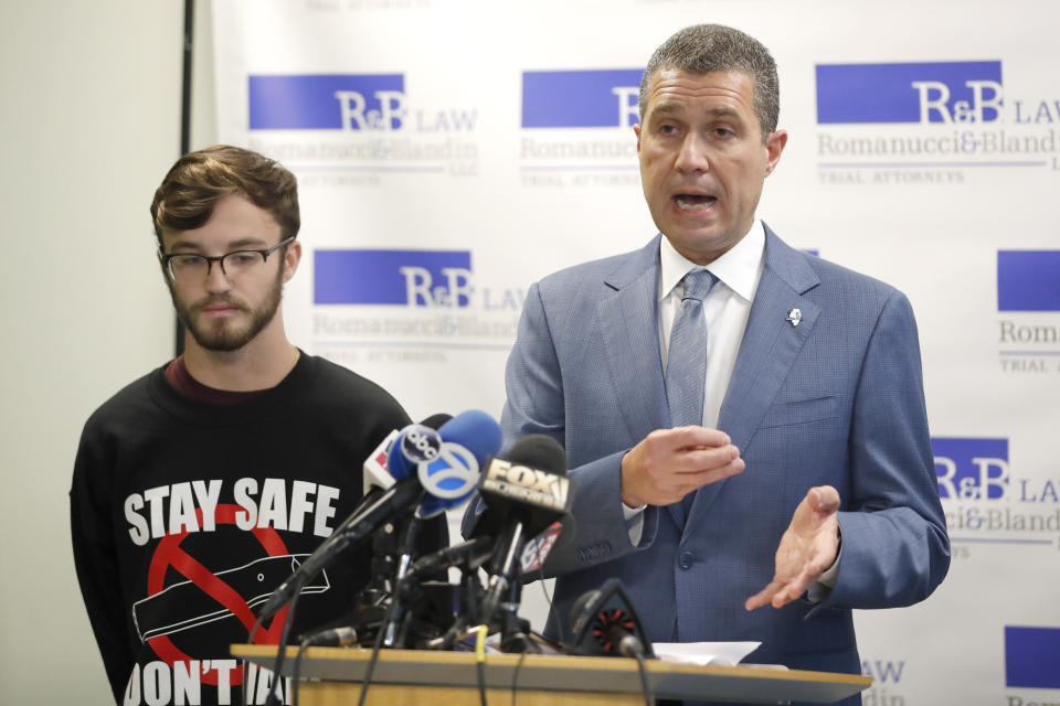Attorney Antonio Romanucci, right, announces the filing of a civil lawsuit against e-cigarette maker Juul on behalf of his client Adam Hergenreder, left, during a news conference Friday, Sept. 13, 2019, in Chicago. The lawsuit filed Friday in Lake County, Illinois, Circuit Court alleges Juul Labs, Inc., deliberately targeted young people through Instagram and other sites to suggest vaping can boost their social status. It also says Juul doesn't fully disclose their products contain dangerous chemicals. (AP Photo/Charles Rex Arbogast)