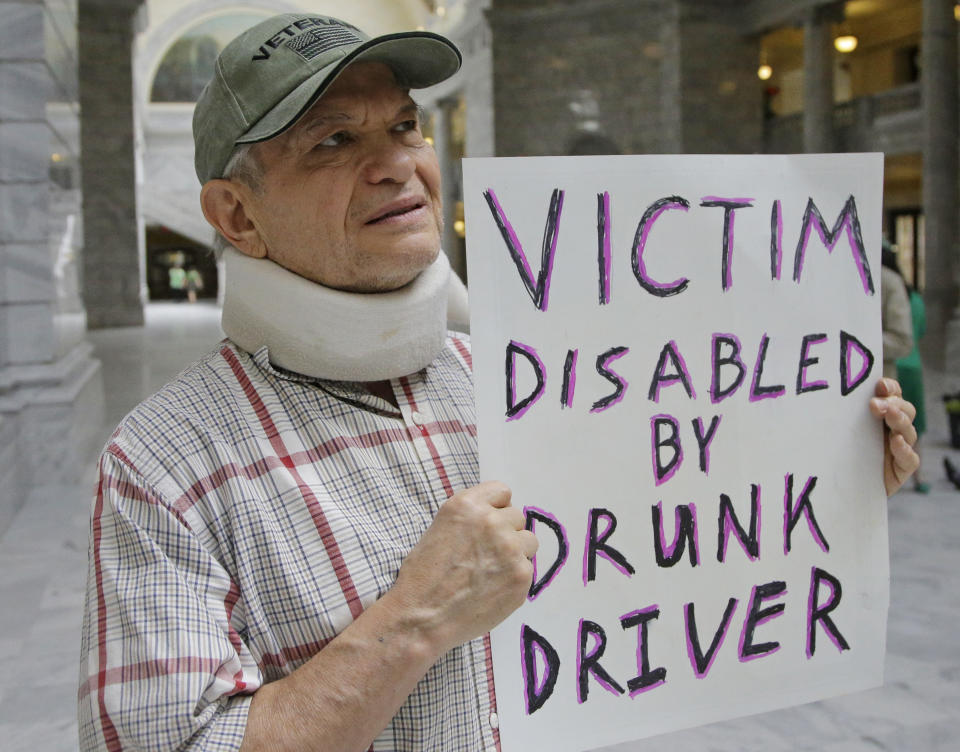 FILE — In this March 17, 2017, file photo, Ed Staley holds a sign during a rally at the Utah State Capitol in Salt Lake City. Car crashes and traffic deaths decreased in Utah the after state enacted the strictest drunken driving laws in the nation. A study published, Friday, Feb. 11, 2022, by the National Highway Traffic Safety Administration suggests Utah's roads became safer after the state lower the drunken driving threshold to .05% blood-alcohol content. (AP Photo/Rick Bowmer, File)