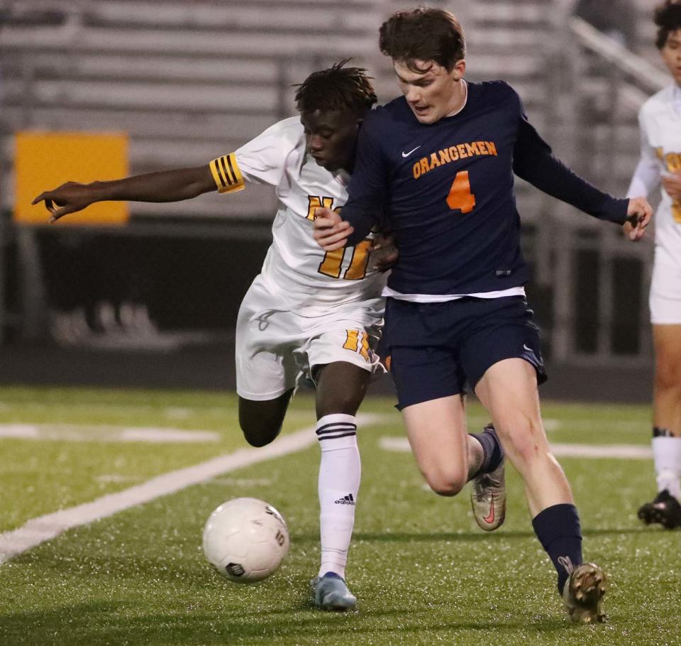 Matiki Mwilebeca, left, of North and Cohen Richardson of Ellet battle for the ball during the first half of their game at Ellet High School on Tuesday. 