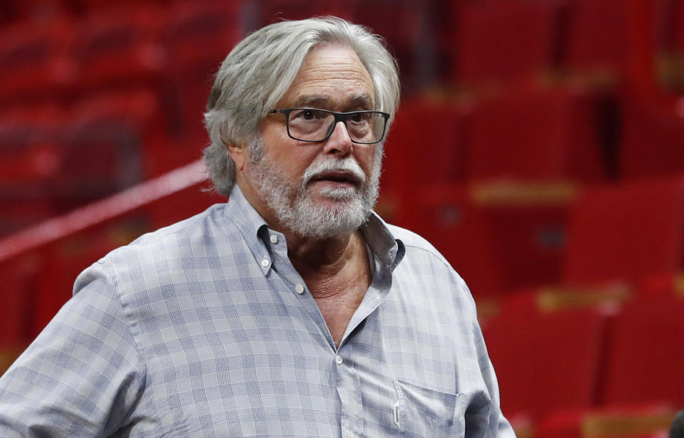 In this March 13, 2019 photo, Micky Arison, Miami Heat managing general partner and chairman of Carnival Cruise Line, walks courtside before the start of an NBA basketball game in Miami. A federal judge has threatened to temporarily block Carnival Corp. from docking cruise ships at ports in the United States as punishment for a possible probation violation. The Miami Herald reports U.S. District Judge Patricia Seitz said Wednesday, April 10, 2019 that she’ll make a decision in June, and she wants company chairman Micky Arison and president Donald Arnold to attend that hearing. (AP Photo/Wilfredo Lee)