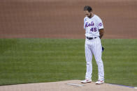 New York Mets starting pitcher Michael Wacha bows his head before the Mets and the Miami Marlins walked off the field before a baseball game, Thursday, Aug. 27, 2020, in New York. The Mets and the Marlins jointly walked off the field after a moment of silence, draping a Black Lives Matter T-shirt across home plate as they chose not to play. (AP Photo/John Minchillo)