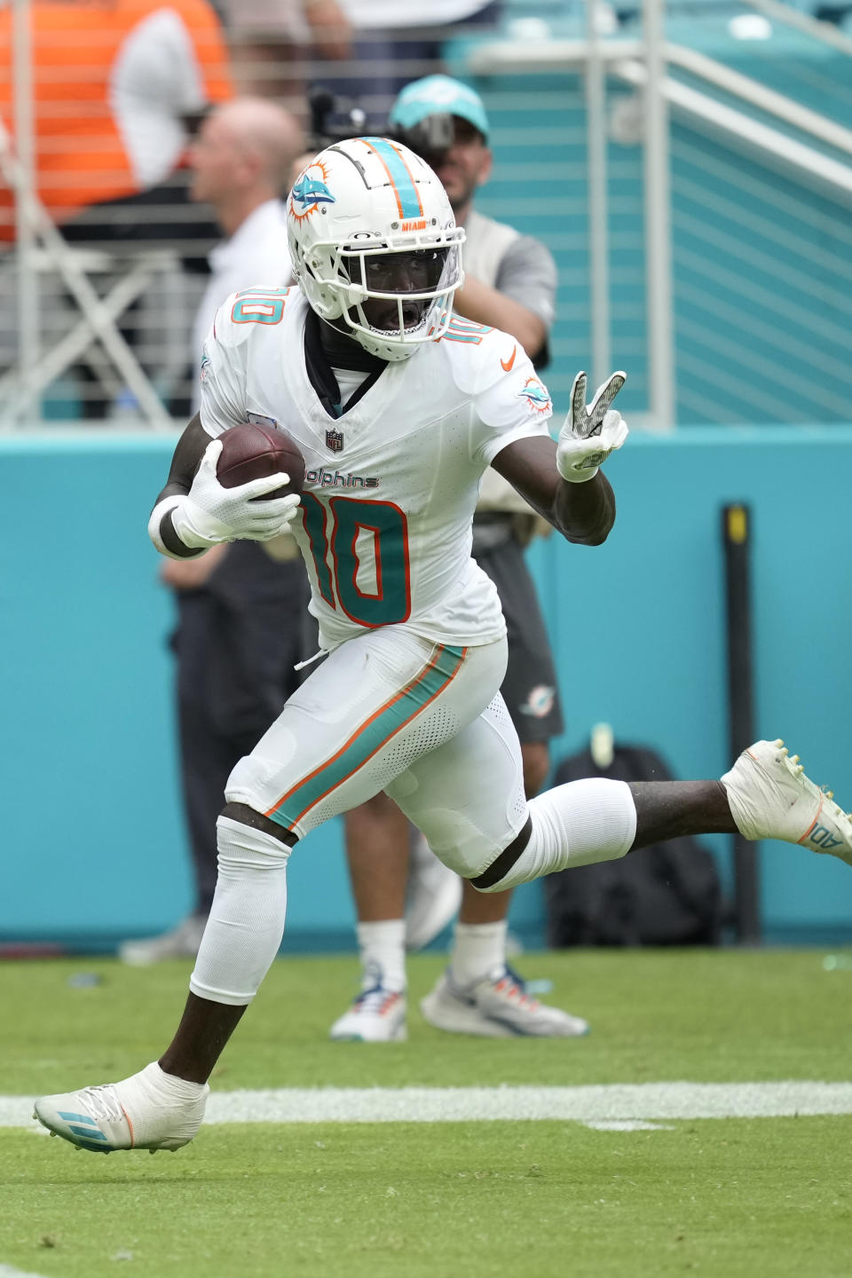 Miami Dolphins wide receiver Tyreek Hill (10) gestures as he runs for a touchdown during the second half of an NFL football game against the New York Giants, Sunday, Oct. 8, 2023, in Miami Gardens, Fla. (AP Photo/Rebecca Blackwell)