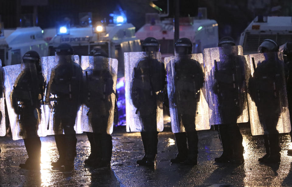 Police block a road near the Peace Wall in West Belfast, Northern Ireland, Thursday, April 8, 2021. Authorities in Northern Ireland sought to restore calm Thursday after Protestant and Catholic youths in Belfast hurled bricks, fireworks and gasoline bombs at police and each other. It was the worst mayhem in a week of street violence in the region, where Britain's exit from the European Union has unsettled an uneasy political balance. (AP Photo/Peter Morrison)