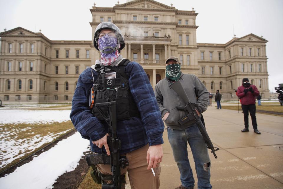 A member of the Boogaloo Bois attends a protest outside of the Michigan State Capitol building in downtown Lansing on Sunday, Jan. 17, 2021.