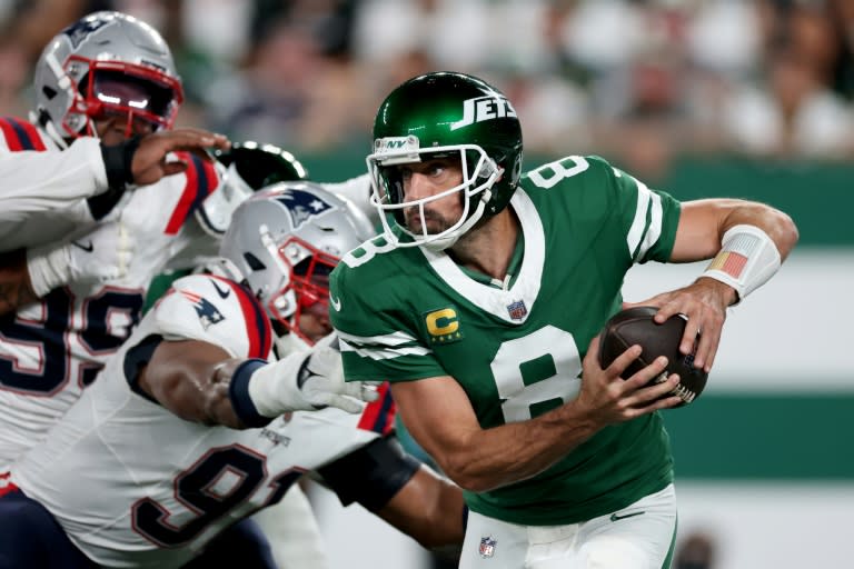 New York Jets quarterback Aaron Rodgers scrambles in an NFL victory over the New England Patriots (AL BELLO)