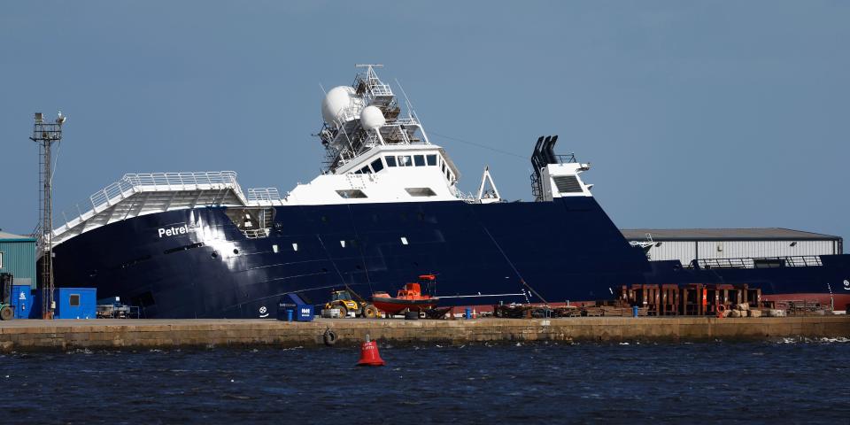 A general view at the scene after a ship tipped over at a 45-degree angle in the Imperial Dock area in Leith on March 22, 2023 in Leith, Scotland.