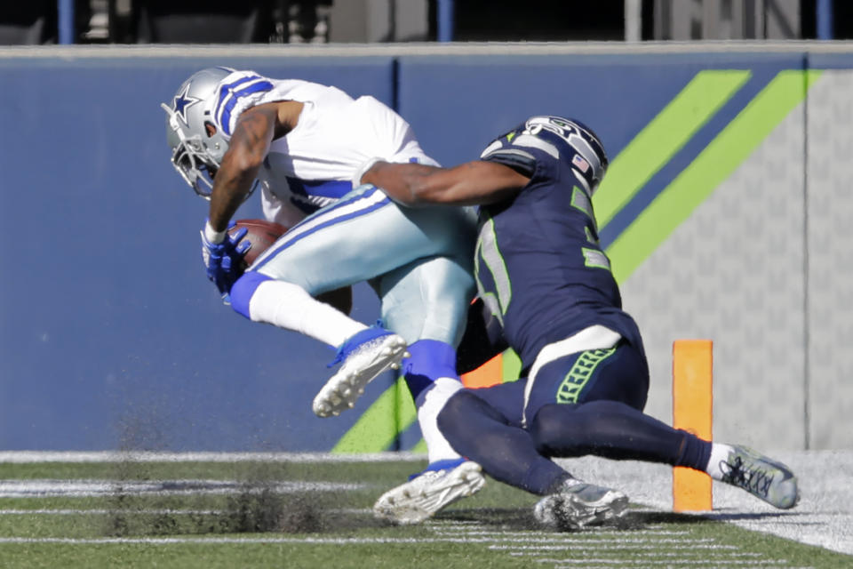 Dallas Cowboys wide receiver Ced Wilson is tackled by Seattle Seahawks free safety Quandre Diggs as Wilson scores a touchdown during the first half of an NFL football game, Sunday, Sept. 27, 2020, in Seattle. (AP Photo/John Froschauer)