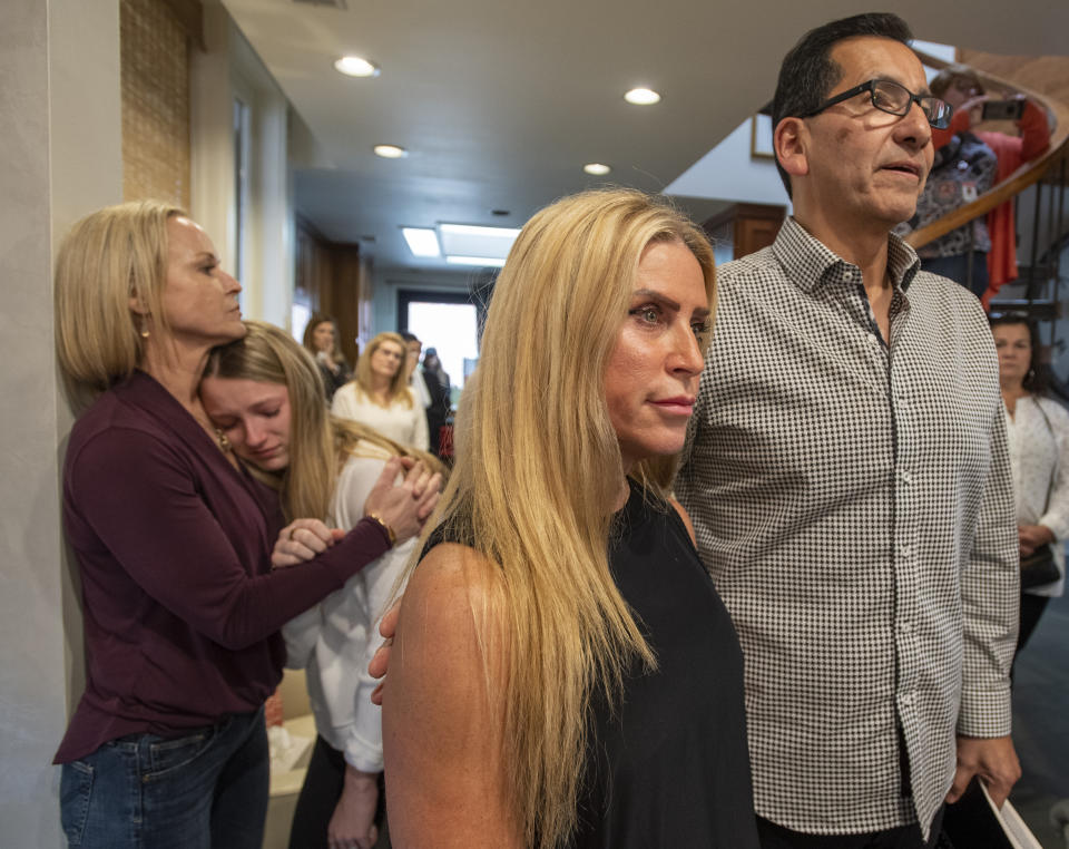 Our Savior's Church Pastor Jacob Aranza, right, says a prayer for Walker Vincent with Leslie Jacob during a 16th birthday party for Walker on Sunday, December 29, 2019 in Lafayette, La. Walker Vincent was one of the victims in the plane crash on Saturday. Family and friends threw him a birthday party where they released LSU balloons and marked gifts with their favorite memories of Walker for his father. (Brad Kemp/The Advocate via AP)