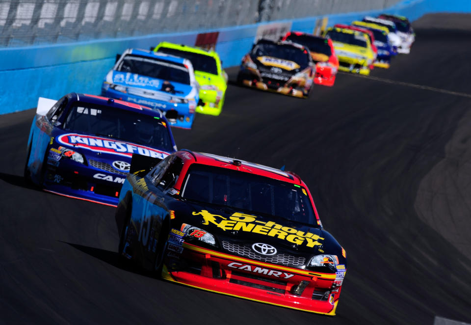 AVONDALE, AZ - MARCH 04: Clint Bowyer, driver of the #15 5-hour Energy Toyota, drives ahead of a group of cars during the NASCAR Sprint Cup Series SUBWAY Fresh Fit 500 at Phoenix International Raceway on March 4, 2012 in Avondale, Arizona. (Photo by Robert Laberge/Getty Images for NASCAR)