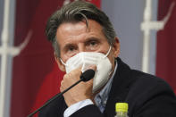 Sebastian Coe, president of World Athletics, listens to a reporter's question during a press conference as Coe visited an athletics test event for the Tokyo 2020 Olympics Games at National Stadium in Tokyo, Sunday, May 9, 2021. (AP Photo/Shuji Kajiyama)