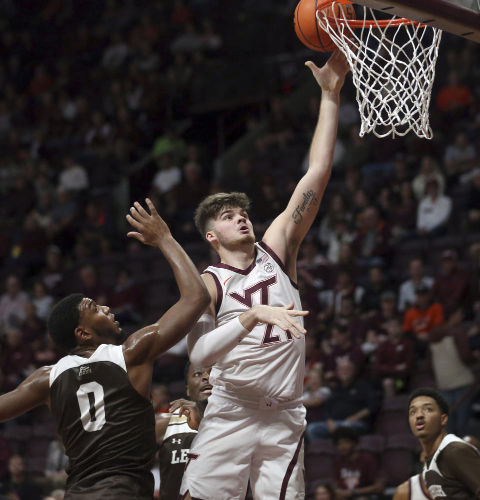 Virginia Tech's Grant Basile (21) scores past Lehigh's Jakob Alamudun (0) during the first half of an NCAA college basketball game Thursday, Nov. 10, 2022, in Blacksburg, Va. (Matt Gentry/The Roanoke Times via AP)