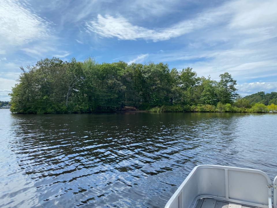 Residents near Sabbatia Lake in Taunton say this island on the lake, seen here on Monday, Aug. 14, 2023 from a boat, has been attracting out-of-towners partying on the island every weekend for a month.