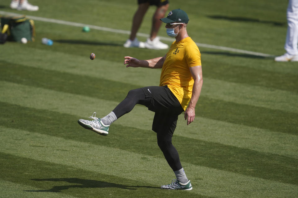 Oakland Athletics' Mark Canha kicks a footbag during a baseball workout in Oakland, Calif., Monday, Sept. 28, 2020. The Athletics are scheduled to play the Chicago White Sox in an American League wild-card playoff series starting Tuesday. (AP Photo/Jeff Chiu)