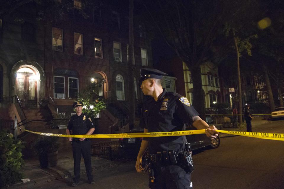 Policemen string police tape outside the Brooklyn residence Cathleen Alexis, mother of suspected Washington Navy Yard shooter Aaron Alexis, in New York September 16, 2013. (REUTERS/Andrew Kelly)