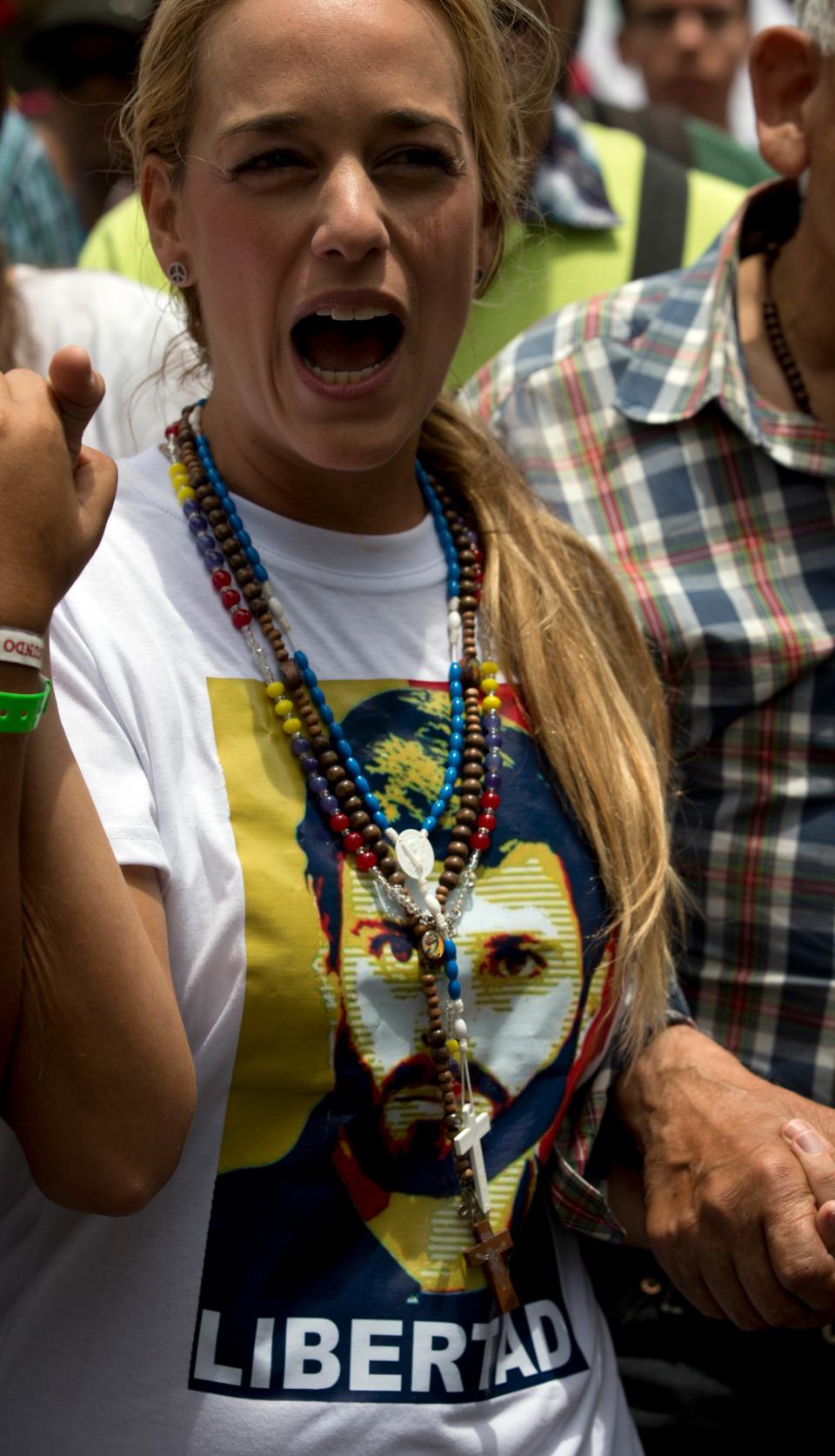 Lilian Tintori wife of jailed opposition leader Leopoldo Lopez shouts slogans against Venezuela's President Nicolas Maduro during an anti-government protest in Caracas, Venezuela, Saturday, April 26, 2014. Student organizers at the last minute decided against marching downtown to avoid a confrontation with security forces in the government-controlled district. Instead they concentrated in the wealthier, eastern neighborhoods that have been the hotbed of unrest since February. (AP Photo/Fernando Llano)