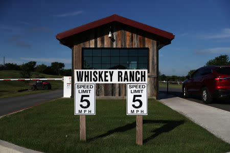Signs are seen at the entrance to the Firestone & Robertson (F&R) Whiskey Ranch in Forth Worth, Texas, U.S., May 24, 2018. REUTERS/Adrees Latif