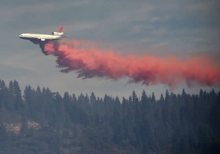 A DC-10 tanker drops fire retardant on the King Fire near Fresh Pond, California September 17, 2014. REUTERS/Noah Berger