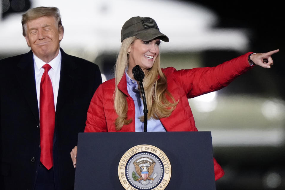 Sen. Kelly Loeffler, R-Ga., speaks as President Donald Trump listens during a campaign rally in support of Senate candidates Sen. Kelly Loeffler, R-Ga., and David Perdue in Dalton, Ga., Monday, Jan. 4, 2021. (AP Photo/Brynn Anderson)