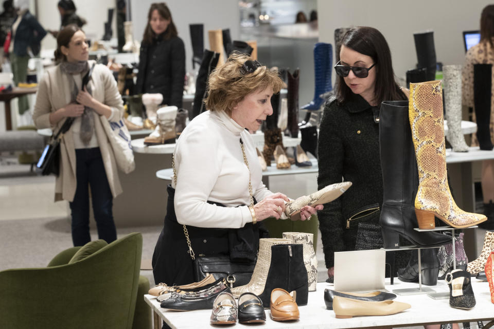 In this Tuesday, Nov. 26, 2019, photo shows customers shopping in the shoe department at the Nordstrom NYC Flagship in New York. "Clearly, shopping is much more about an experience," said Jamie Nordstrom, president of Nordstrom stores and the great-grandson of the company's founder. “It's not just about getting through their lists. They want to bump into something new, something they didn't come into find. I think great stores do that well." (AP Photo/Mary Altaffer)