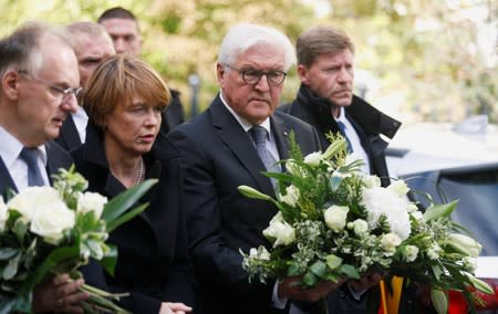 Saxony-Anhalt State Premier Reiner Haseloff, German President Frank-Walter Steinmeier and his wife Elke Budenbender are seen outside the synagogue in Halle