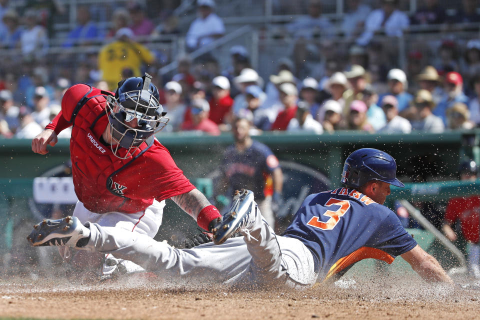 Houston Astros' Myles Straw slides safely into home plate as Boston Red Sox catcher Christian Vazquez is too late with the tag during a spring training baseball game, Thursday, March 5, 2020, in Fort Myers, Fla. (AP Photo/Elise Amendola)