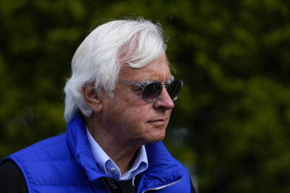 Bob Baffert, center, owner of Preakness Stakes entrant National Treasure, walks near the stables ahead of the 148th running of the Preakness Stakes horse race at Pimlico Race Course, Friday, May 19, 2023, in Baltimore. (AP Photo/Julio Cortez)