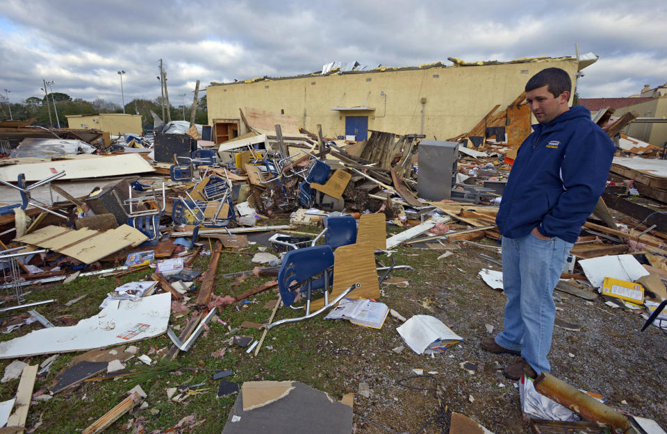 <p> FILE - In this photo taken Dec. 26, 2012, Murphy High School teacher Ryan Little looks around at the student desks and other items scattered from temporary classrooms demolished by a Christmas Day tornado at Murphy High School in Mobile, Ala. The Alabama Legislature could authorize the borrowing of $280 million through state bond issues Monday, May 20, 2013 to finance everything from more secure school entrances to electronic tablets for students. With the Republican-controlled Legislature repeatedly making it clear that new taxes are off the table, lawmakers are increasingly turning to bond issues to provide money. Several bills will provide $30 million in bonds to pay for repairs to schools damaged by tornadoes in 2011 and 2012, including $15 million for Murphy High School in Mobile and $8 million for schools in the Tuscaloosa area. (AP Photo/G.M. Andrews, file)</p>
