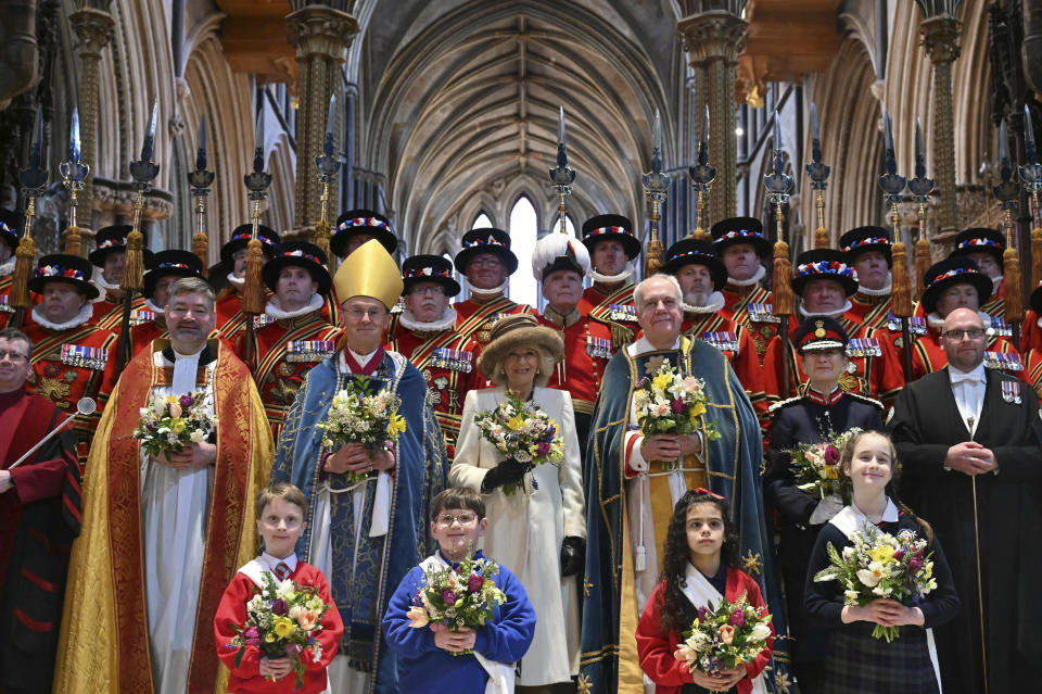 Britain's Queen Camilla, center, poses for a photograph with the Maundy Party during the Royal Maundy Service where she distributes the Maundy money to 75 men and 75 women, mirroring the age of the monarch, in Worcester Cathedral, Worcester, England, Thursday, March 28, 2024. Maundy Thursday is the Christian holy day falling on the Thursday before Easter. The monarch commemorates Maundy by offering 'alms' to senior citizens. Each recipient receives two purses, one red and one white. (Justin Tallis, Pool Photo via AP)