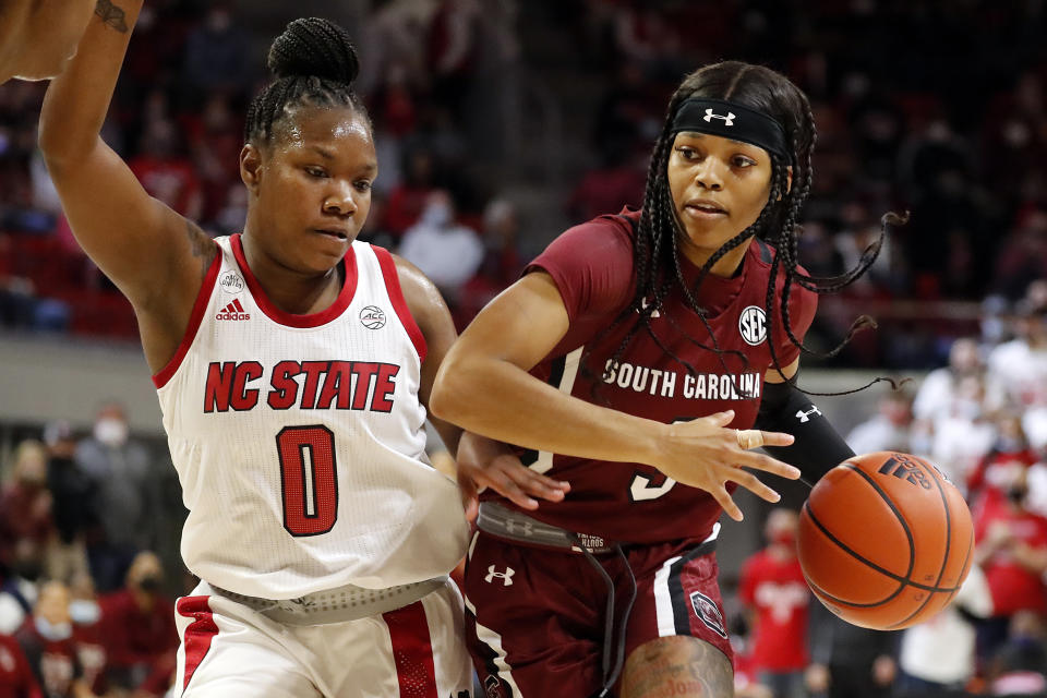 South Carolina's Destanni Henderson (3) drives the ball around North Carolina State's Diamond Johnson (0) during the second half of an NCAA college basketball game, Tuesday, Nov. 9, 2021 in Raleigh, N.C. (AP Photo/Karl B. DeBlaker)