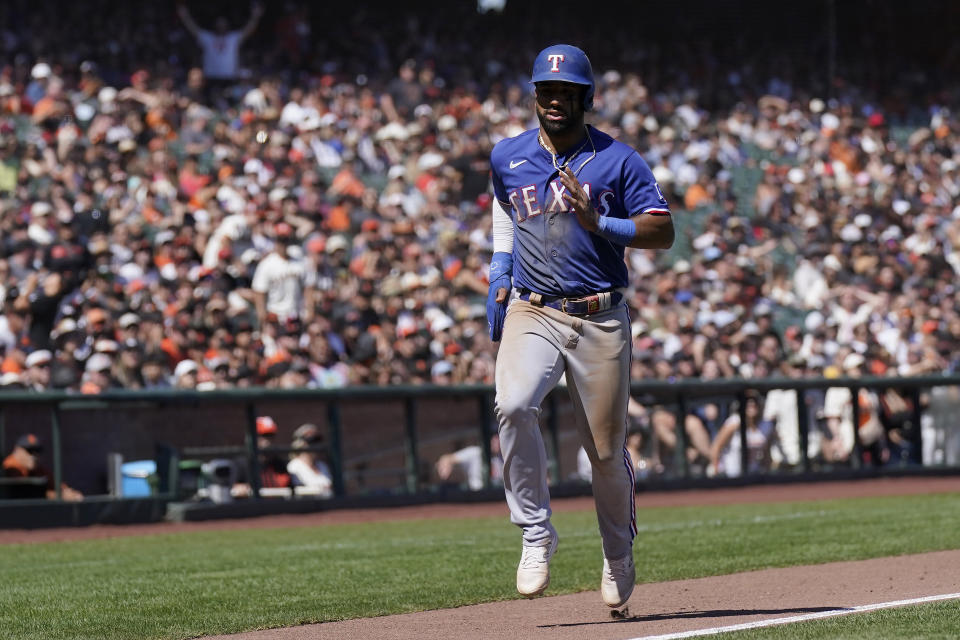 Texas Rangers' Ezequiel Duran scores on a balk called on San Francisco Giants pitcher Camilo Doval during the tenth inning of a baseball game in San Francisco, Sunday, Aug. 13, 2023. (AP Photo/Jeff Chiu)