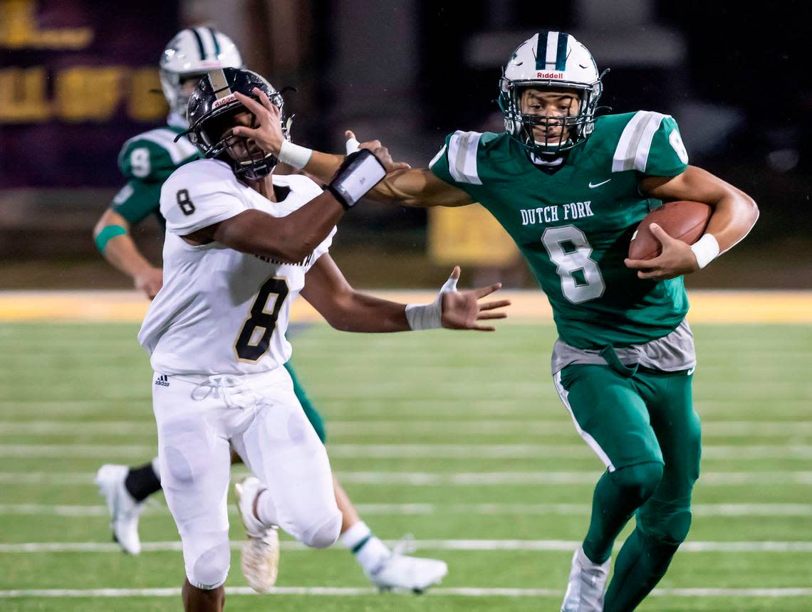 Antonio Williams (right) of Dutch Fork High School gives a stiff arm to Kamren Johnson of T. L. Hanna High School during the SCHSL Class AAAAA football state finals held Saturday, December 4, 2019 at Charles W. Johnson Stadium in Columbia.