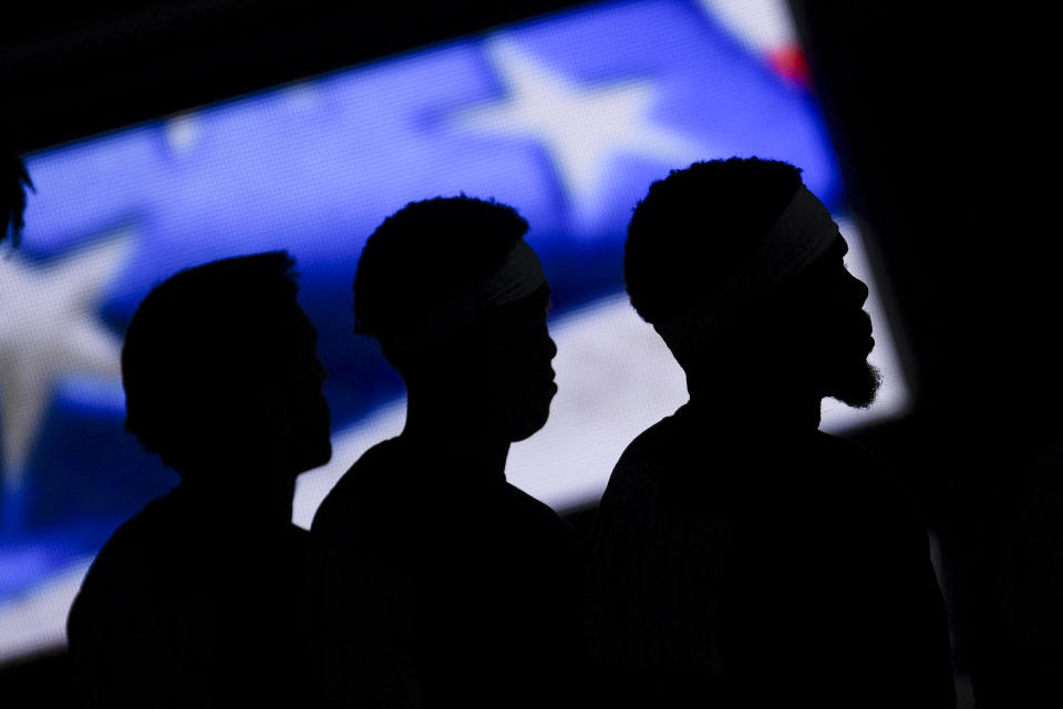 Facundo Campazzo (7), R.J. Hampton (13) and Paul Millsap (4) of the Denver Nuggets stand for the national anthem.