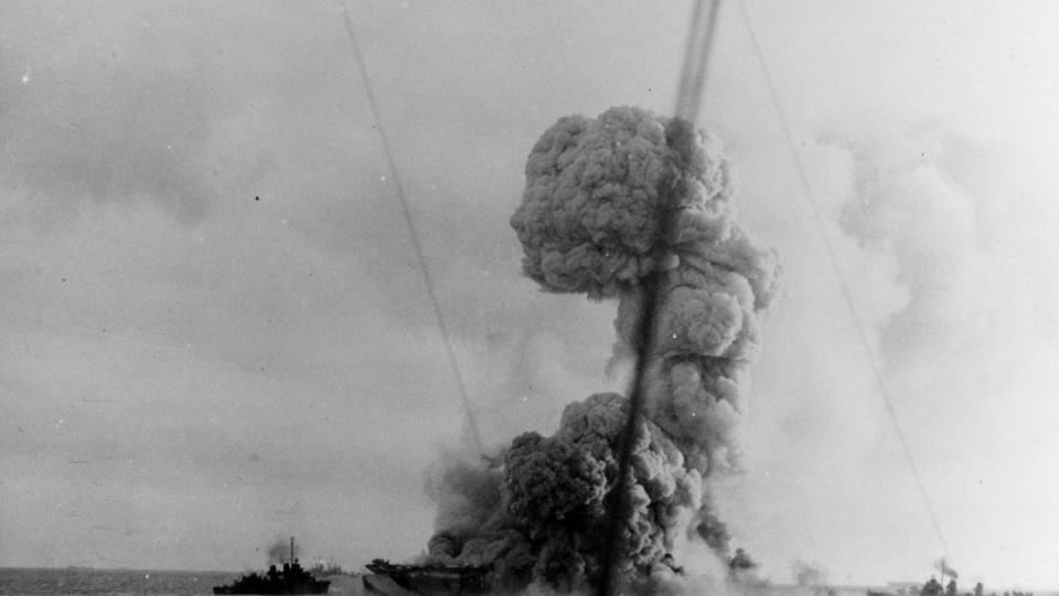 Smoke billows from the Ommaney Bay. (Naval History and Heritage Command)