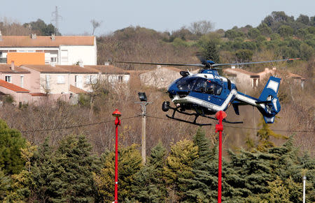 A gendarmerie helicopter flies over the village of Trebes after a hostage situation in a supermarket, France, March 23, 2018. REUTERS/Jean-Paul Pelissier