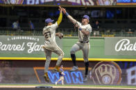 Milwaukee Brewers player Willy Adames and Joey Wiemer celebrate a win over the Tampa Bay Rays folloowng a baseball game Wednesday, May 1, 2024, in Milwaukee. (AP Photo/Kenny Yoo)