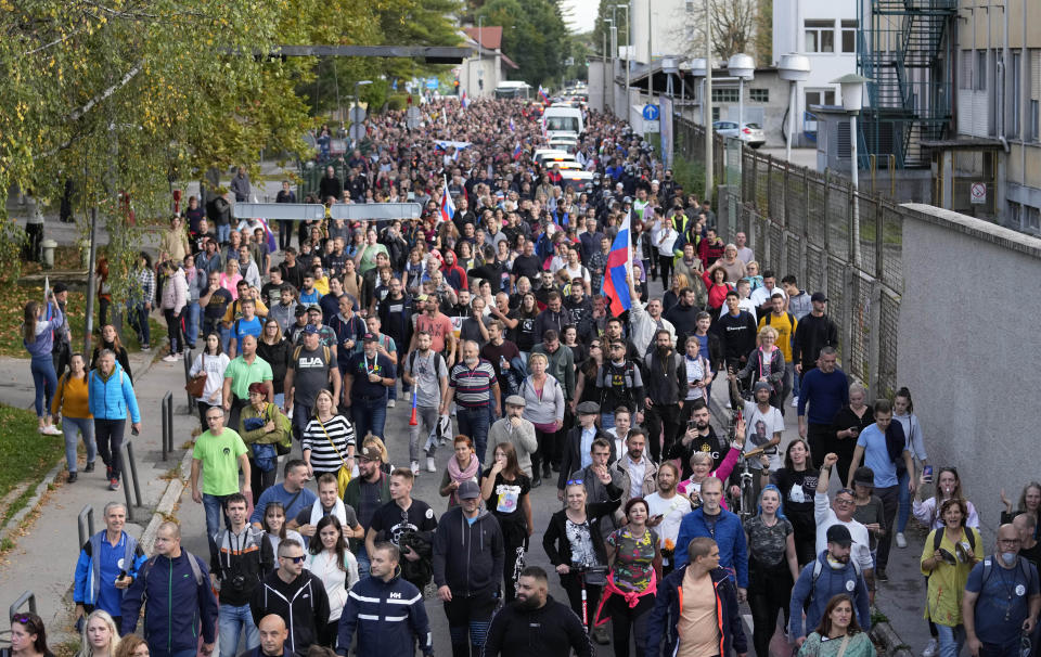 Demonstrators march during a protest against vaccinations and coronavirus measures in Ljubljana, Slovenia, Tuesday, Oct. 5, 2021. EU leaders are meeting Tuesday evening in nearby Kranj, Slovenia, to discuss increasingly tense relations with China and the security implications of the chaotic U.S.-led exit from Afghanistan, before taking part in a summit with Balkans leaders on Wednesday. (AP Photo/Petr David Josek)