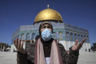 A Muslim woman takes part in Friday prayers at the Dome of the Rock Mosque in the Al Aqsa Mosque complex in the Old City of Jerusalem, which has reopened to visitors following a third lockdown to curb the spread of the coronavirus, Friday, Feb. 12, 2021. (AP Photo/Mahmoud Illean)