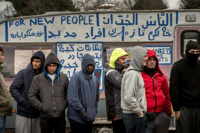 Migrants queue in the so-called 'Jungle' camp in Calais, northern France