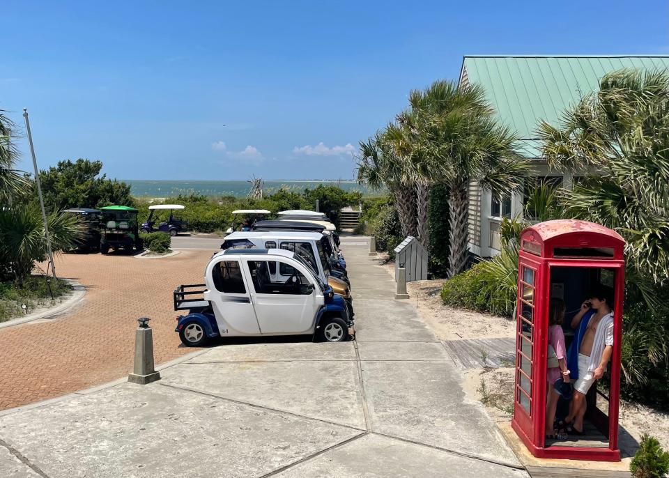 Golf carts fill a parking lot near the ferry terminal on Bald Head Island, where cars are prohibited.
