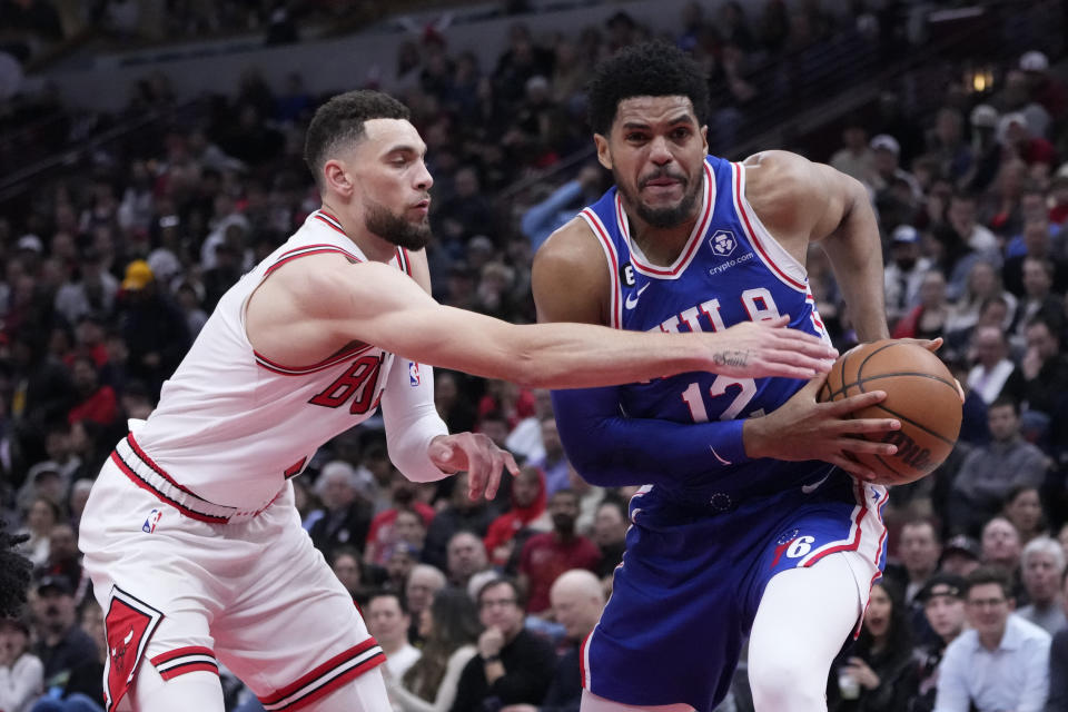 Philadelphia 76ers' Tobias Harris drives to the basket as Chicago Bulls' Zach LaVine defends during the first half of an NBA basketball game Wednesday, March 22, 2023, in Chicago. (AP Photo/Charles Rex Arbogast)