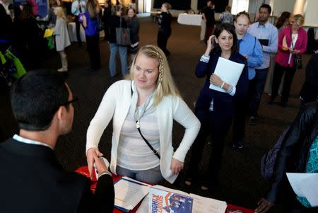 FILE PHOTO: A job seeker talks to a recruiter from UC Health at the Colorado Hospital Association job fair in Denver, Colorado, U.S. on October 4, 2017. REUTERS/Rick Wilking/File Photo