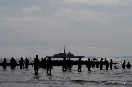 A military ship patrols the area near the Bregancon Fort, in Bregancon.