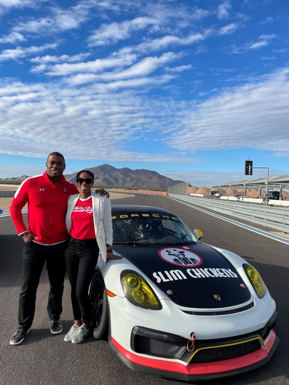 Angelo Crowell (left) and Kim Crowell (right) stands alongside Slim Chickens Porsche