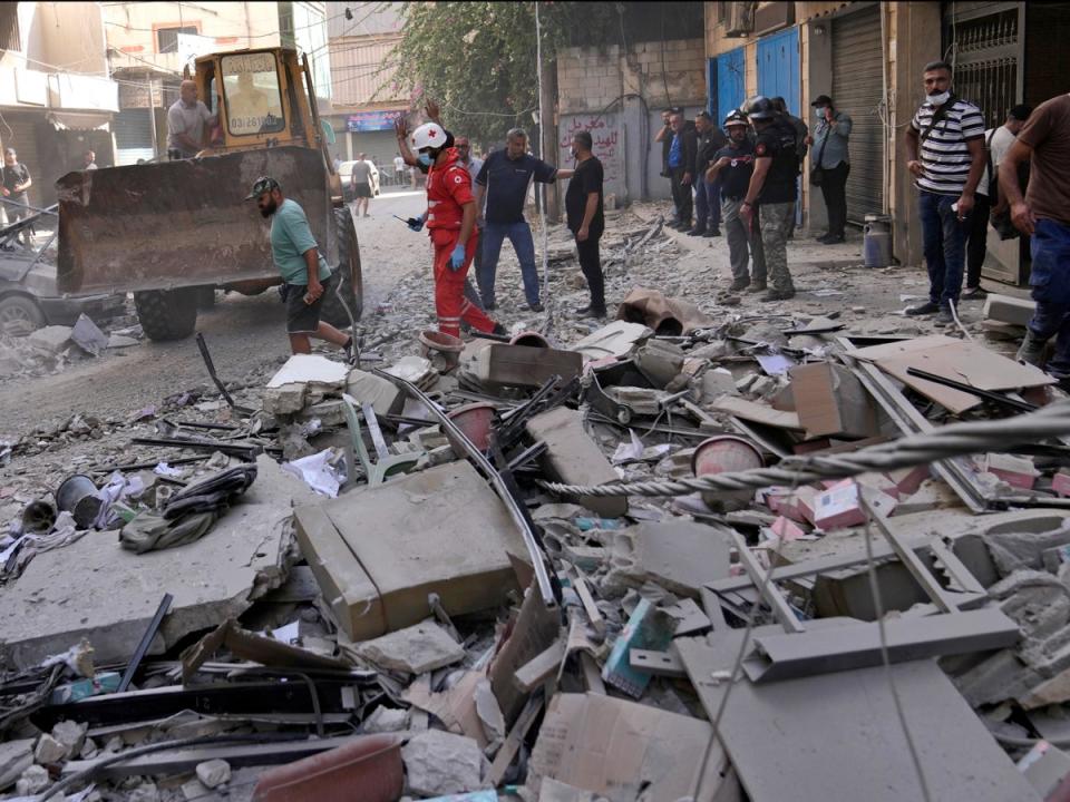 Rescuers at the scene of an Israeli airstrike in Beirut’s suburb of Ghobeiri on Sunday (AP)