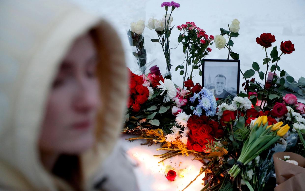 A portrait of late Russian opposition leader Alexei Navalny sits amid flowers at a makeshift memorial outside the Borisovskoye cemetery following his funeral ceremony, in Moscow, Russia, 01 March 2024. Outspoken Kremlin critic Navalny died aged 47 in an arctic penal colony on 16 February 2024 after being transferred there in 2023. The colony is considered to be one of the world's harshest prisons.