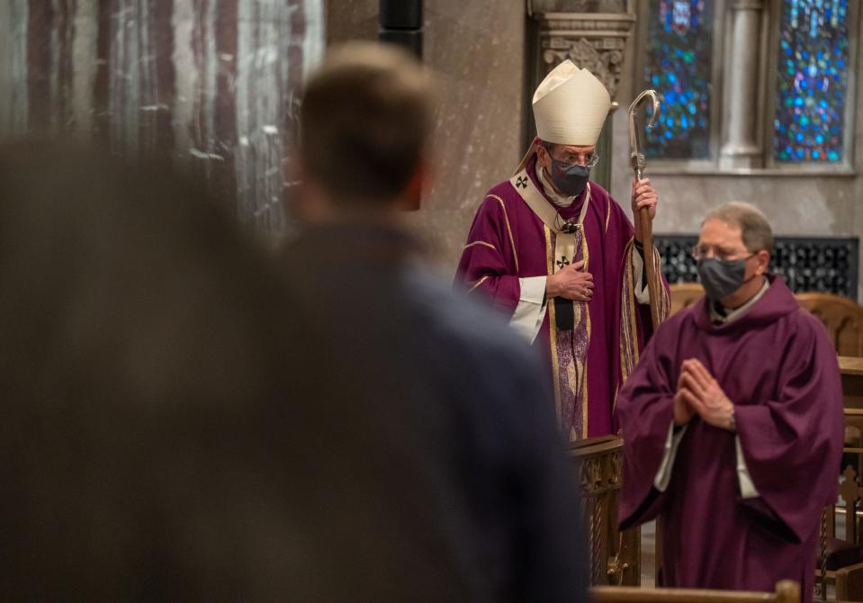 Detroit Archbishop Allen Vigneron (center) exits the altar at the end of an Ash Wednesday Mass at St. Aloysius Church in downtown Detroit on February 17, 2021.