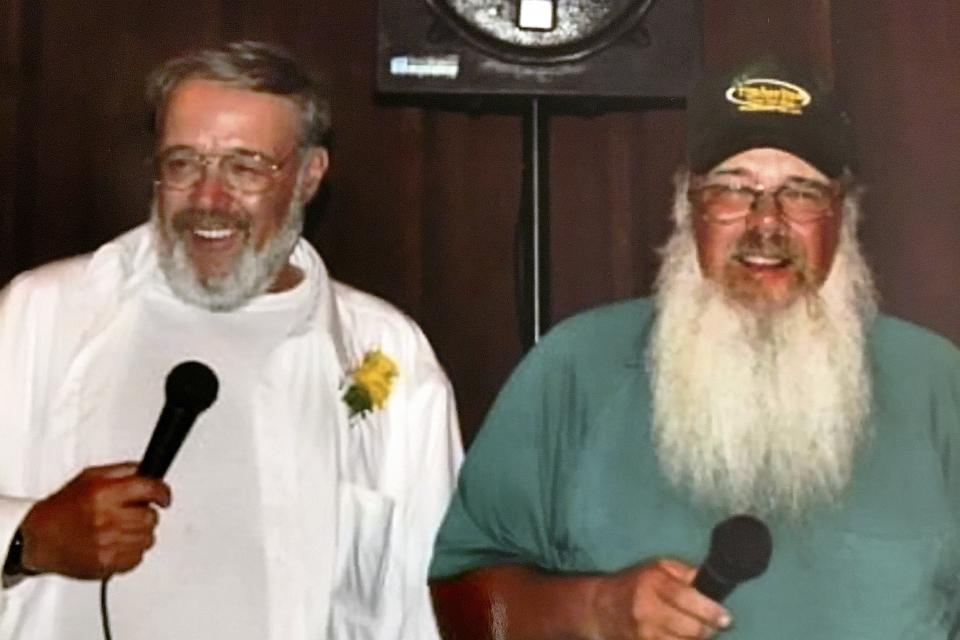 In this Aug. 8, 2012, photo provided by Meghan Boyd Carrier, her father, Cleon Boyd, left, and his twin brother Leon Boyd perform during her wedding in Readsboro, Vt. Cleon died from the coronavirus on April 3, 2020. Leon also died from the coronavirus less than a week later. (Courtesy of Meghan Boyd Carrier via AP)