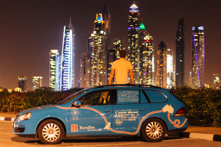 Dutch adventurer Wiebe Wakker on his electric car journey from the Netherlands to Australia, in Dubai, UAE December 2016 in this picture obtained from social media. Picture taken December 2016. WIEBE WAKKER/PLUG ME IN PROJECT/via REUTERS